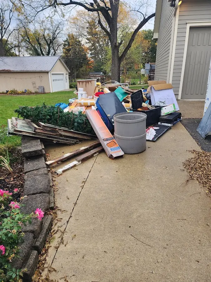 Dumpster being loaded with debris for Estate Cleanout Dumpster Rental in North Arlington